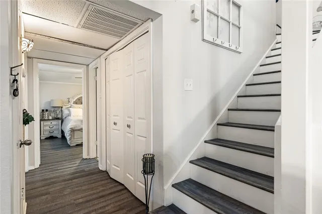 a view of a hallway with wooden floor and entryway