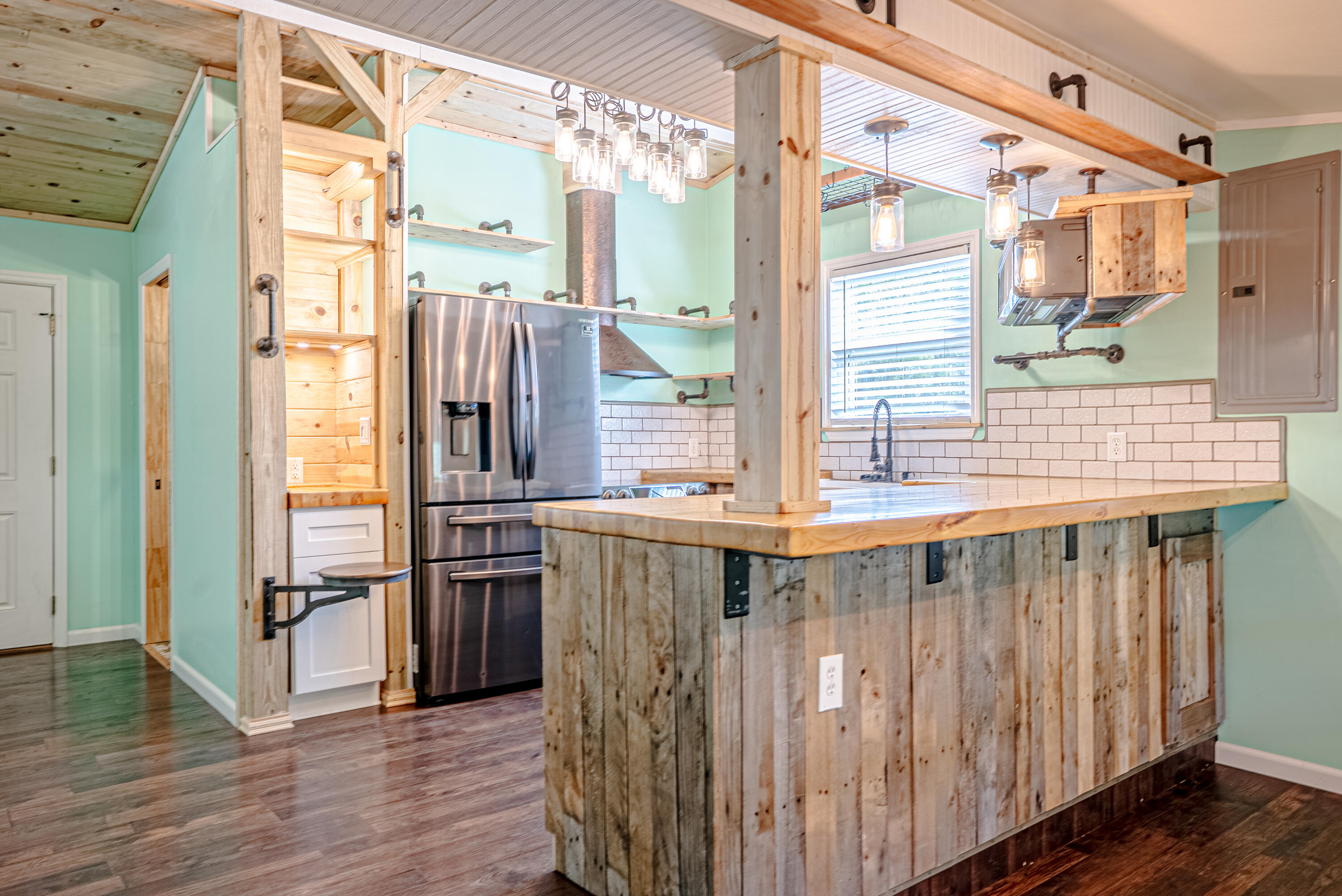 85 Our Street Vernon, FL 32462 - Photo 11 of 66 a kitchen with stainless steel appliances granite countertop a refrigerator and wooden floor