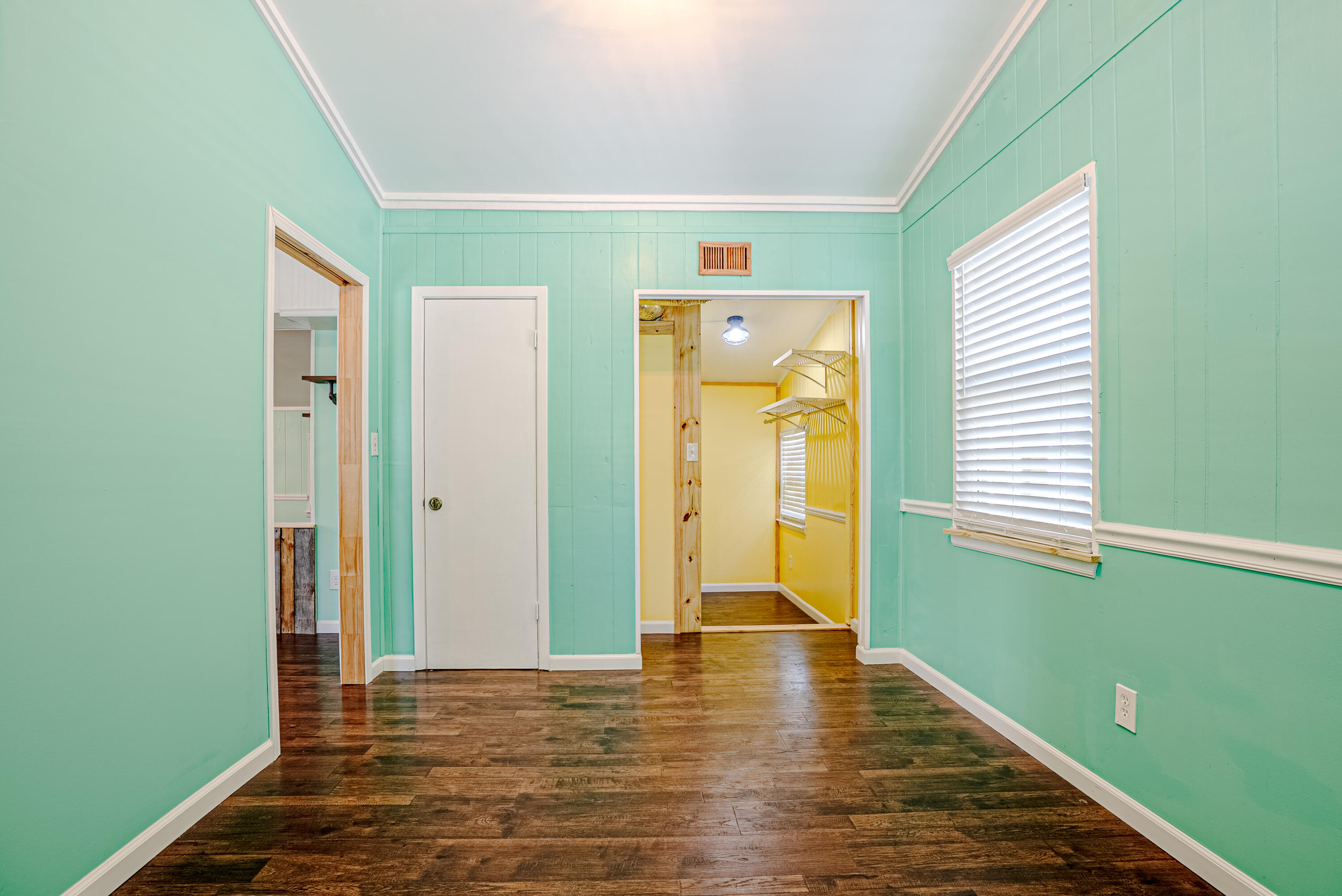 85 Our Street Vernon, FL 32462 - Photo 18 of 66 a view of empty room with wooden floor and fan