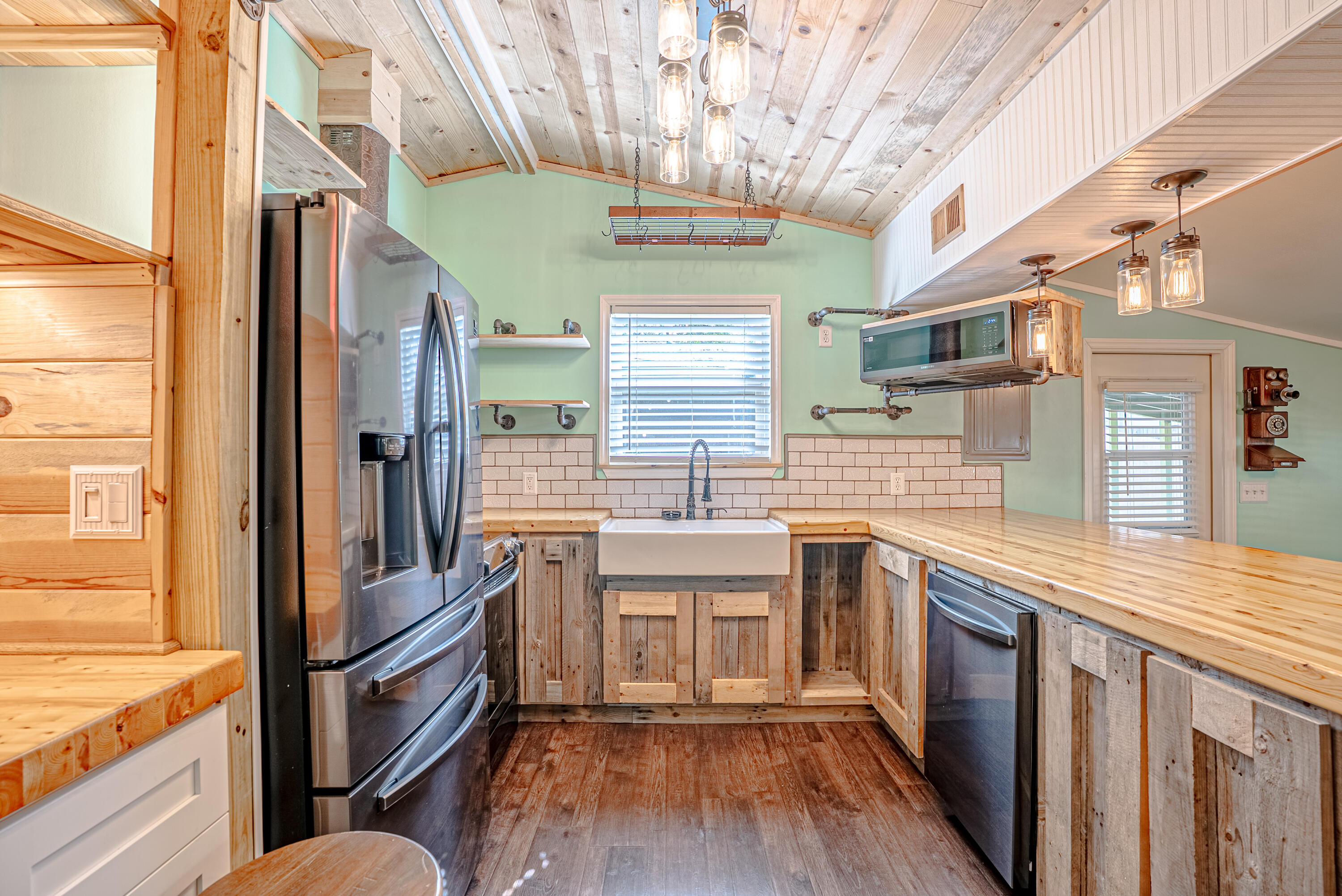 85 Our Street Vernon, FL 32462 - Photo 8 of 66 a kitchen with stainless steel appliances granite countertop a sink and wooden cabinets