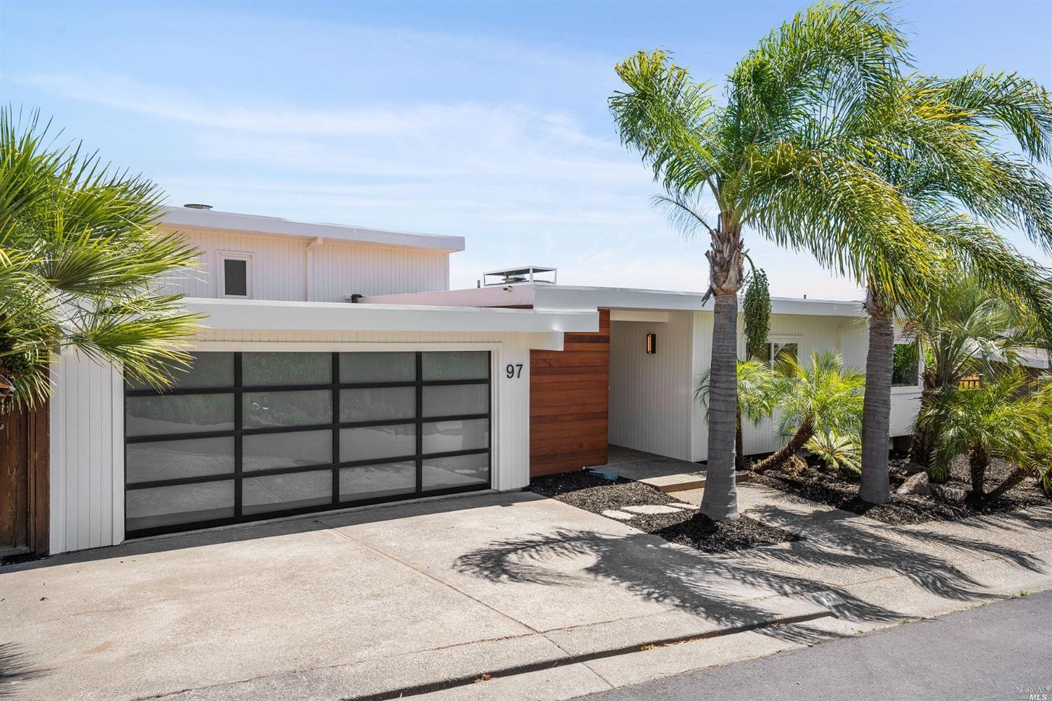 97 Corte Ramon Greenbrae, CA 94904 - Photo 1 of 1 a front view of a house with a yard and garage