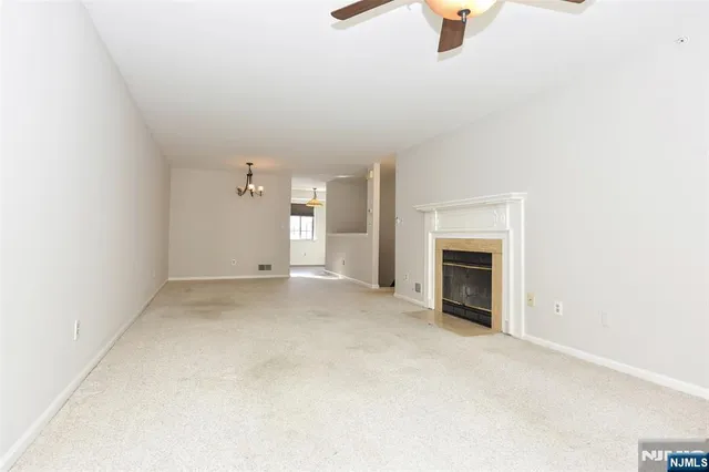 a view of empty room with a fireplace