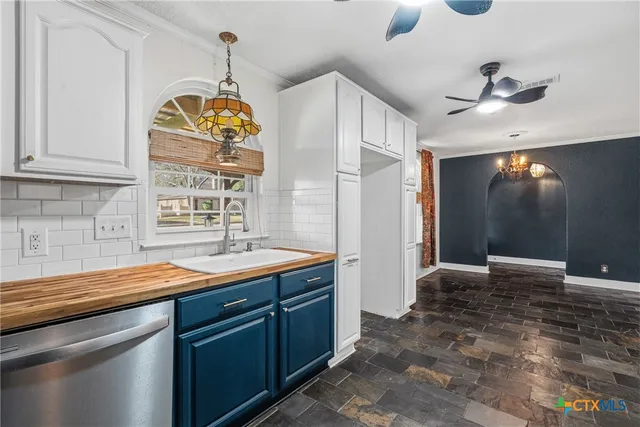 a kitchen with a refrigerator and cabinets