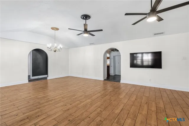 a view of empty room with floor to ceiling windows