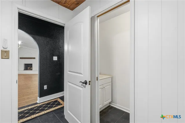 a view of a bedroom with a bed and a window