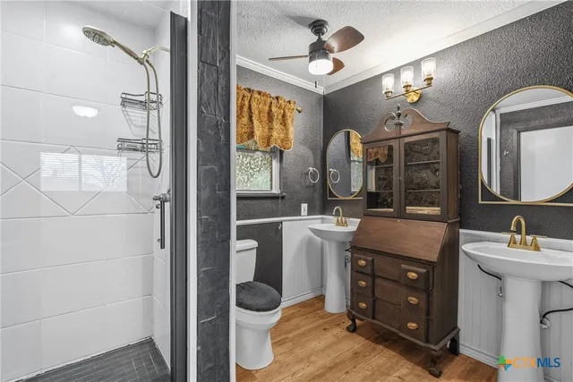 a bathroom with a toilet and a shower
