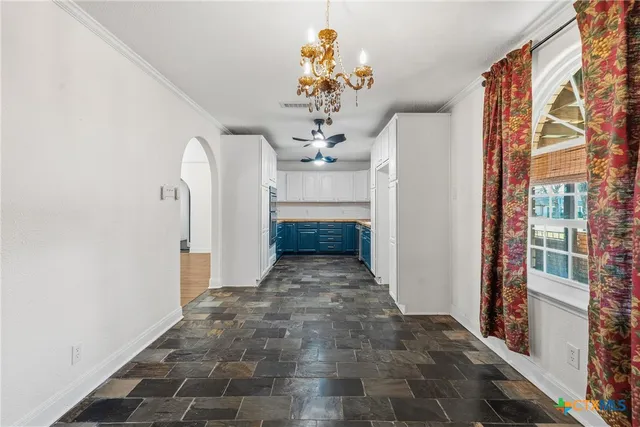 a view of a room with a fireplace and chandelier