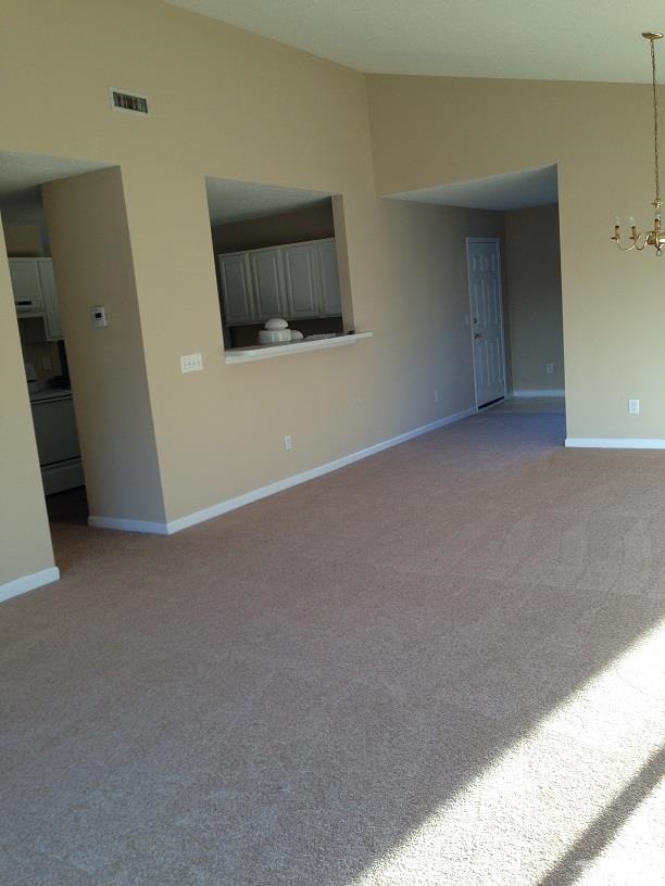4625 Silverdene Street Raleigh, NC 27616 - Photo 2 of 3 a view of an empty room with wooden floor and a window