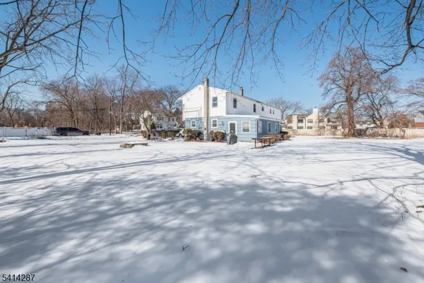 a view of a houses with a snow on the road