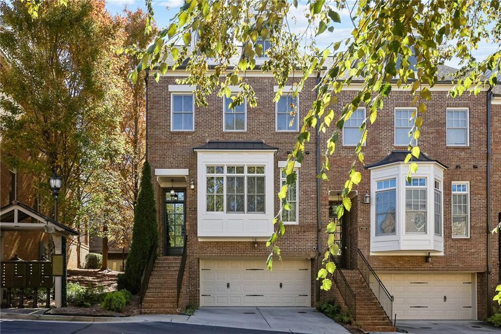 a front view of a building with a tree