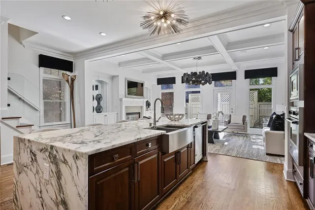 a spacious bedroom with a bed and a chandelier