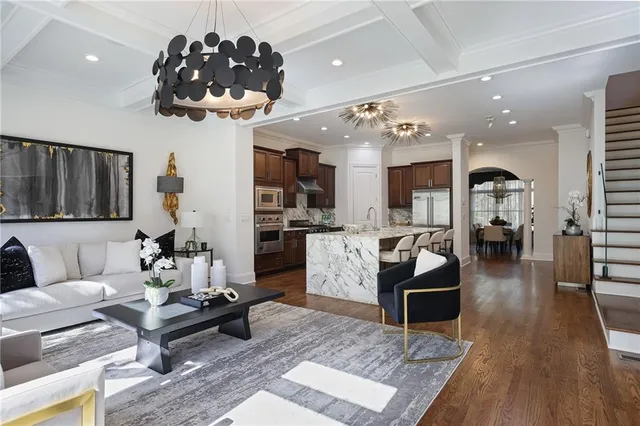 a kitchen with stainless steel appliances granite countertop a sink a stove and a wooden floors