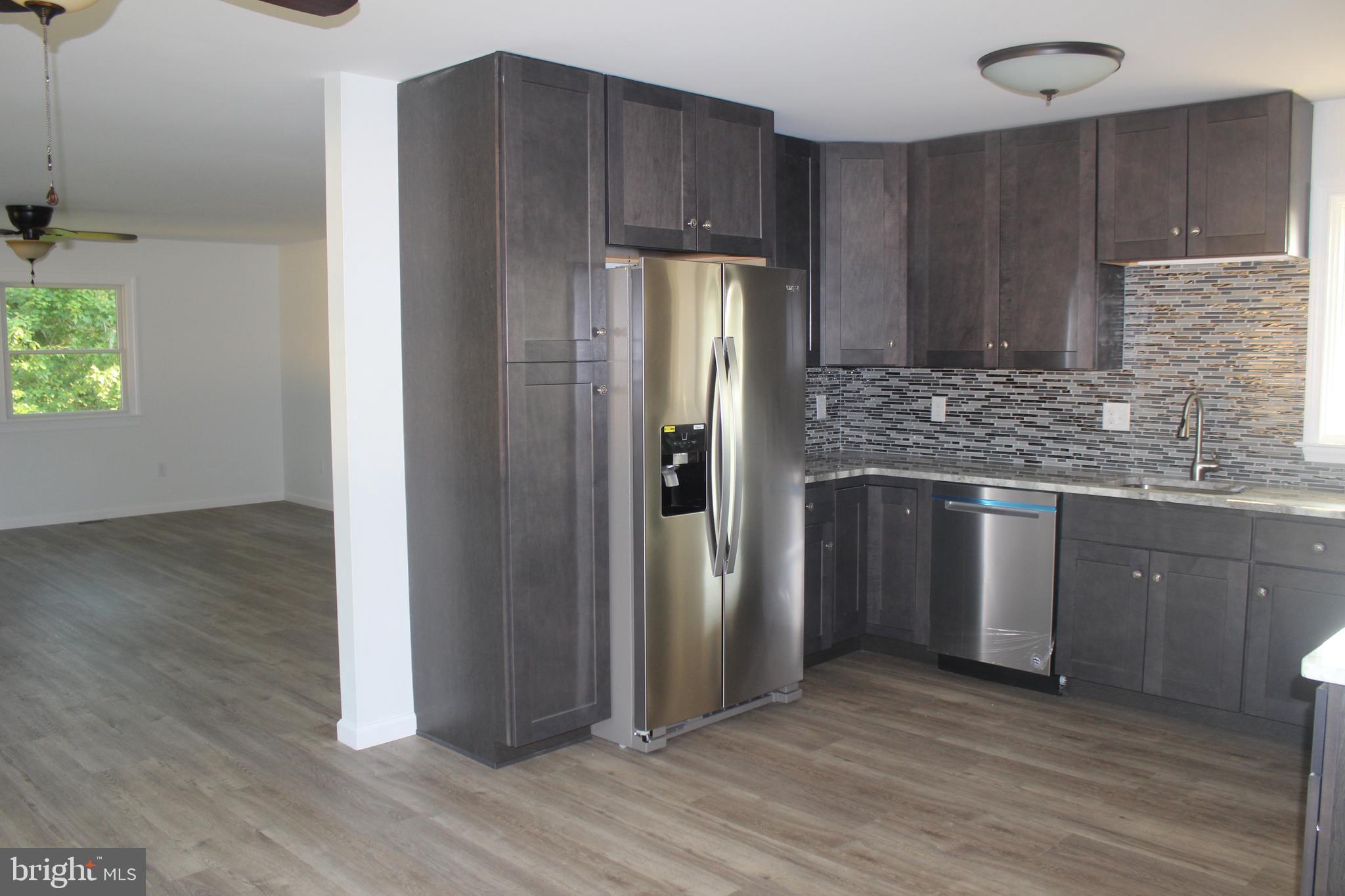 3128 Highway 206 Columbus, NJ 08022 - Photo 3 of 14 a kitchen with stainless steel appliances granite countertop a refrigerator and a sink
