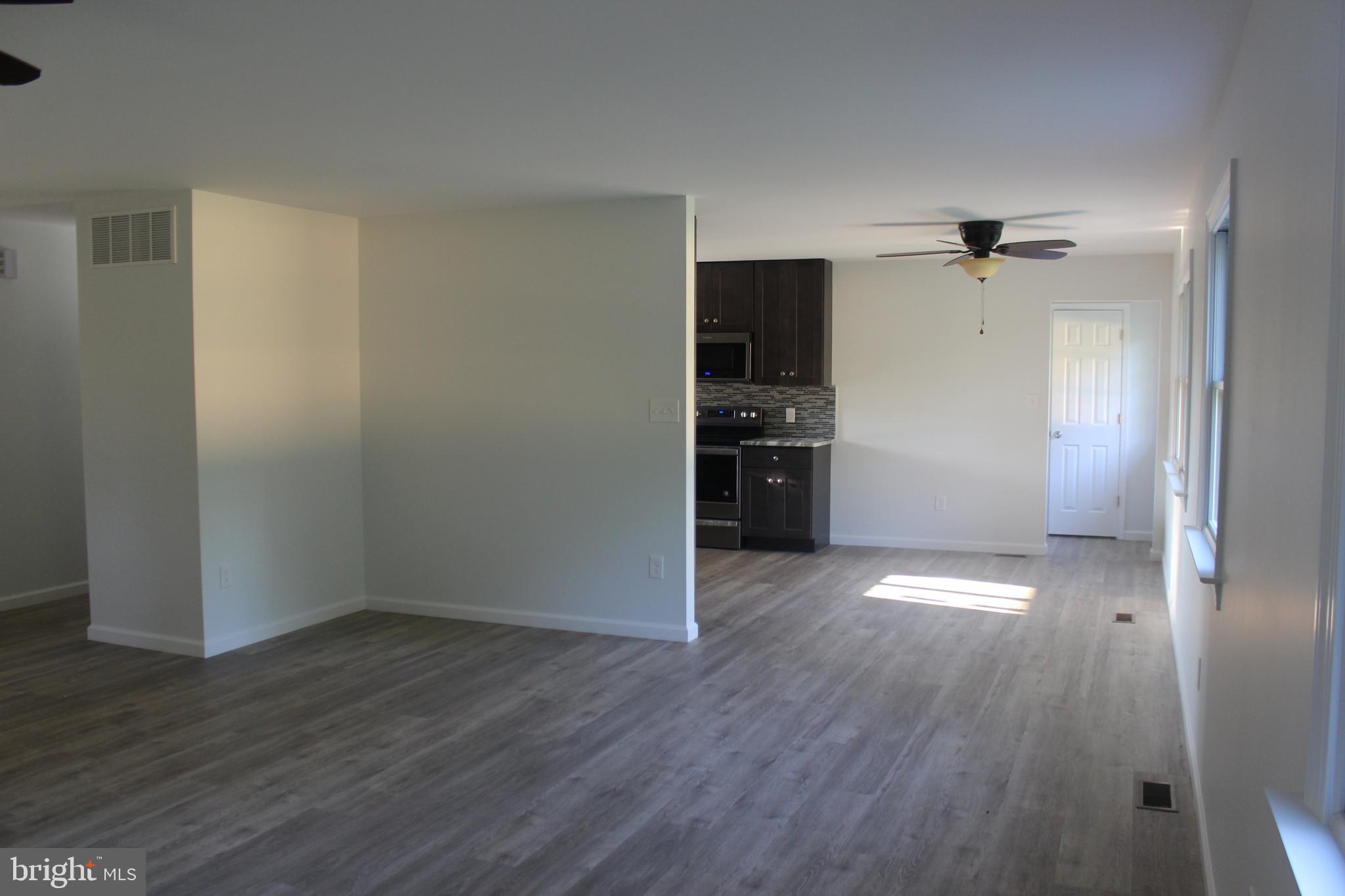 3128 Highway 206 Columbus, NJ 08022 - Photo 4 of 14 wooden floor in an empty room with a window