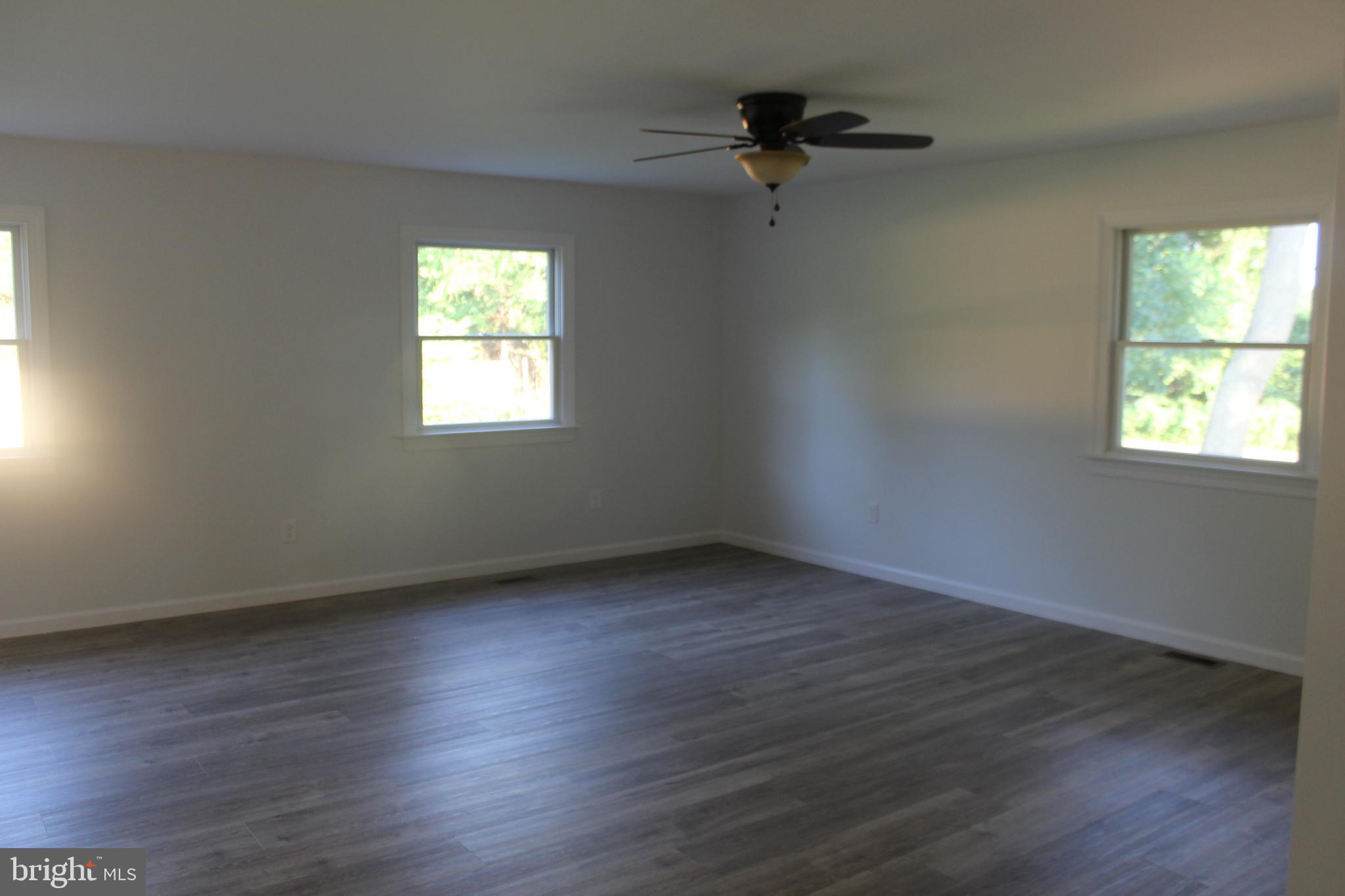 3128 Highway 206 Columbus, NJ 08022 - Photo 5 of 14 a view of an empty room with wooden floor and a window