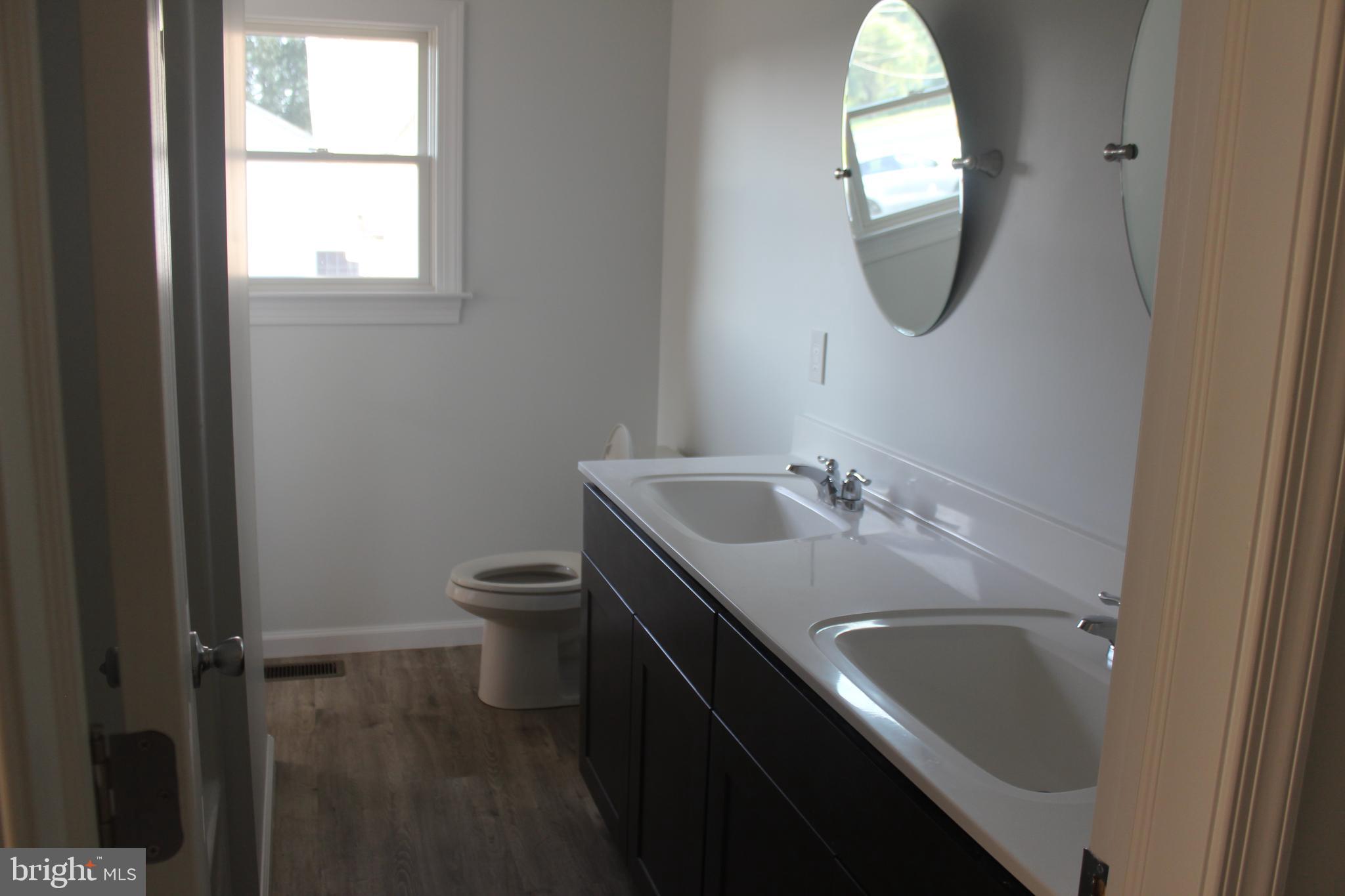 3128 Highway 206 Columbus, NJ 08022 - Photo 6 of 14 a bathroom with a granite countertop sink a toilet and a mirror