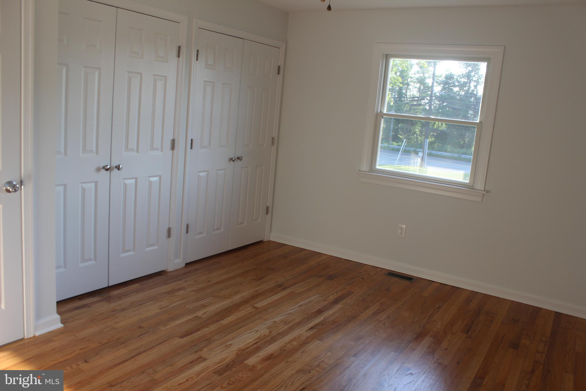 3128 Highway 206 Columbus, NJ 08022 - Photo 7 of 14 a view of an empty room with wooden floor and a window