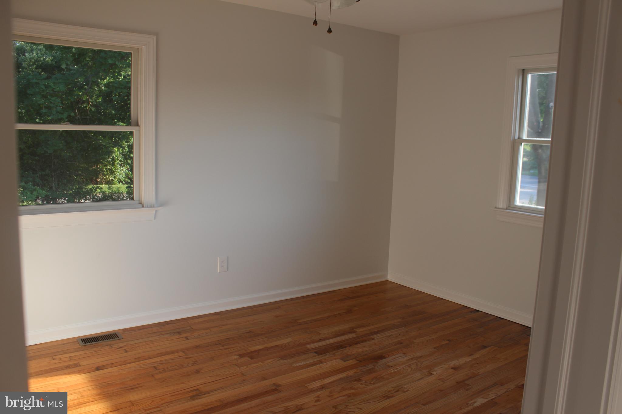 3128 Highway 206 Columbus, NJ 08022 - Photo 8 of 14 an empty room with wooden floor and windows