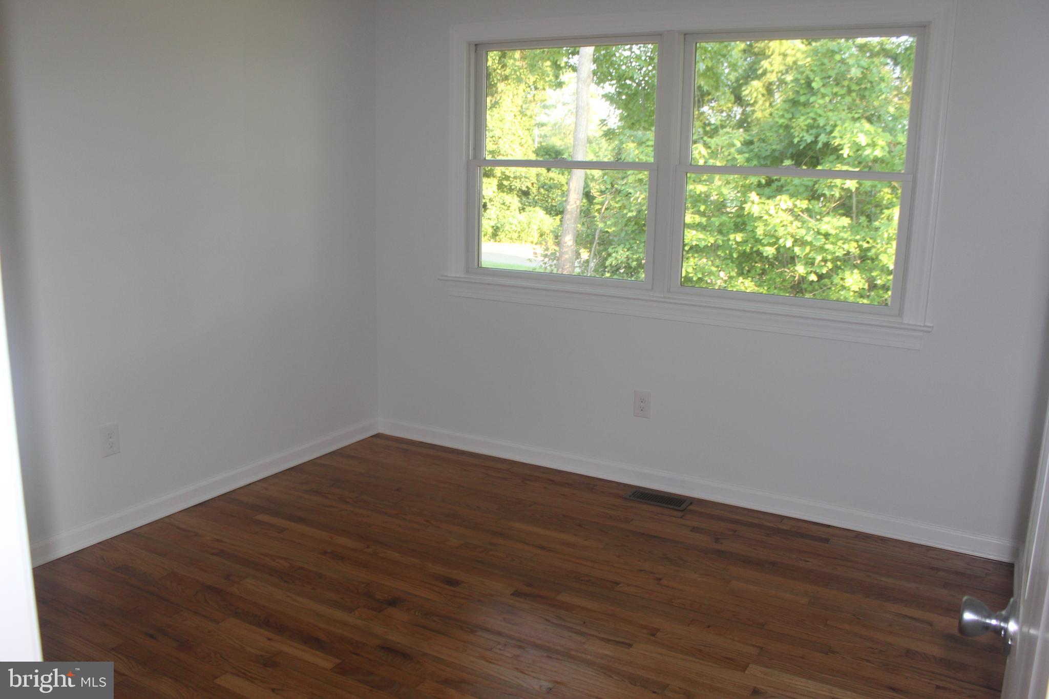 3128 Highway 206 Columbus, NJ 08022 - Photo 9 of 14 an empty room with wooden floor and windows