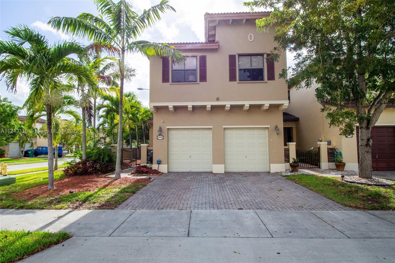 22737 Southwest 89th Path Cutler Bay, FL 33190 - Photo 1 of 27 a view of a house with a yard and palm trees