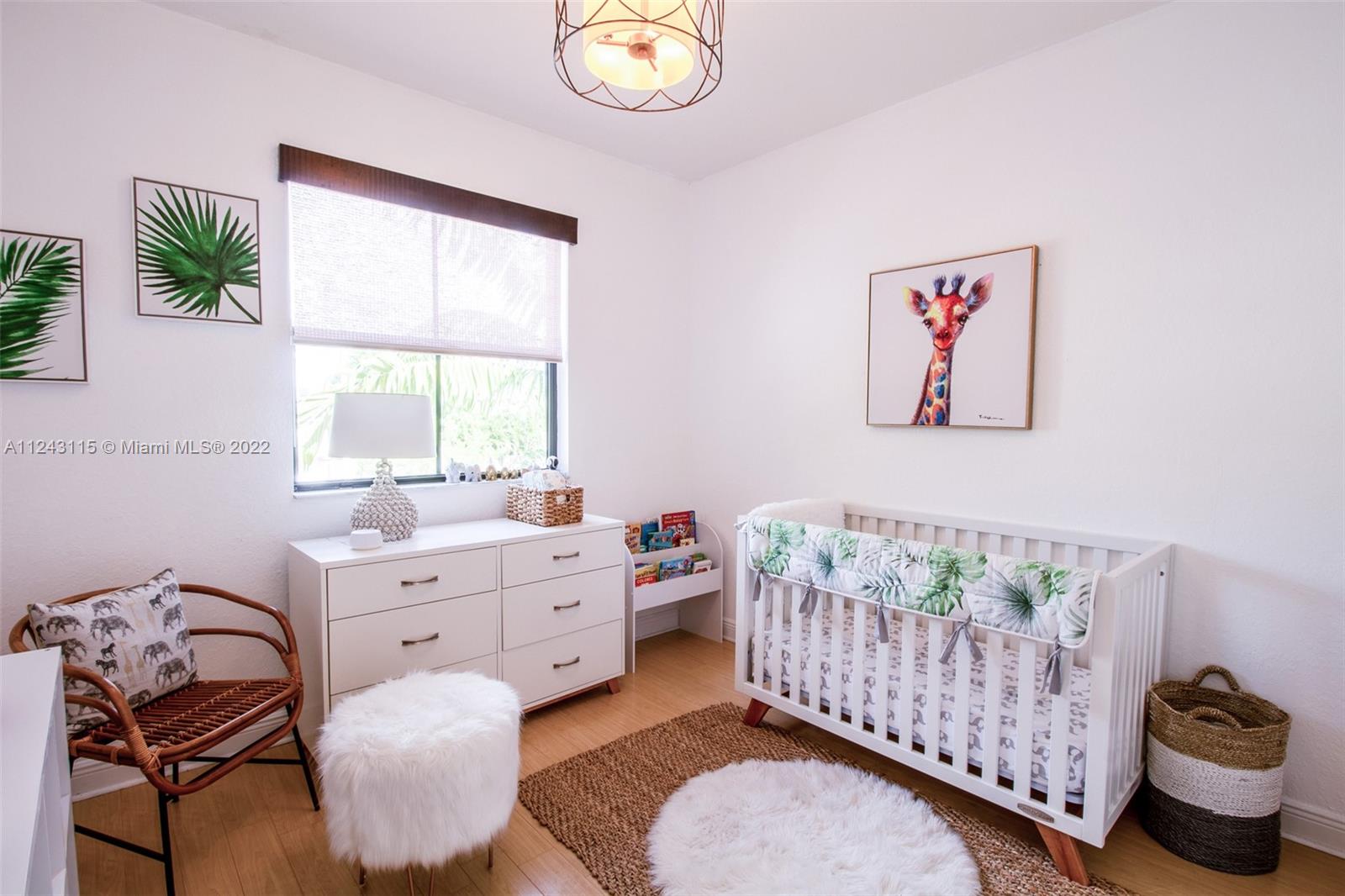 22737 Southwest 89th Path Cutler Bay, FL 33190 - Photo 12 of 27 a bedroom with a bed and a window