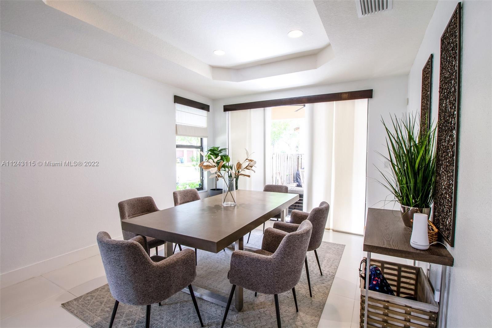22737 Southwest 89th Path Cutler Bay, FL 33190 - Photo 14 of 27 a view of a dining room with furniture and a potted plant