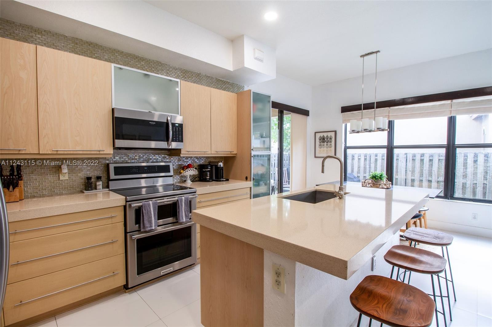 22737 Southwest 89th Path Cutler Bay, FL 33190 - Photo 19 of 27 a kitchen with a stove a sink and a refrigerator