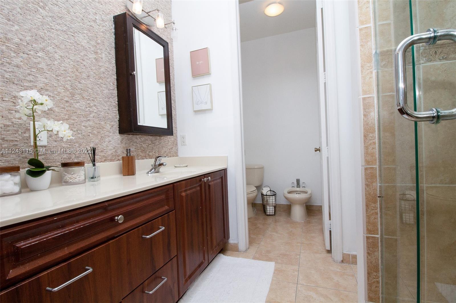 22737 Southwest 89th Path Cutler Bay, FL 33190 - Photo 7 of 27 a spacious bathroom with a double vanity sink and a mirror
