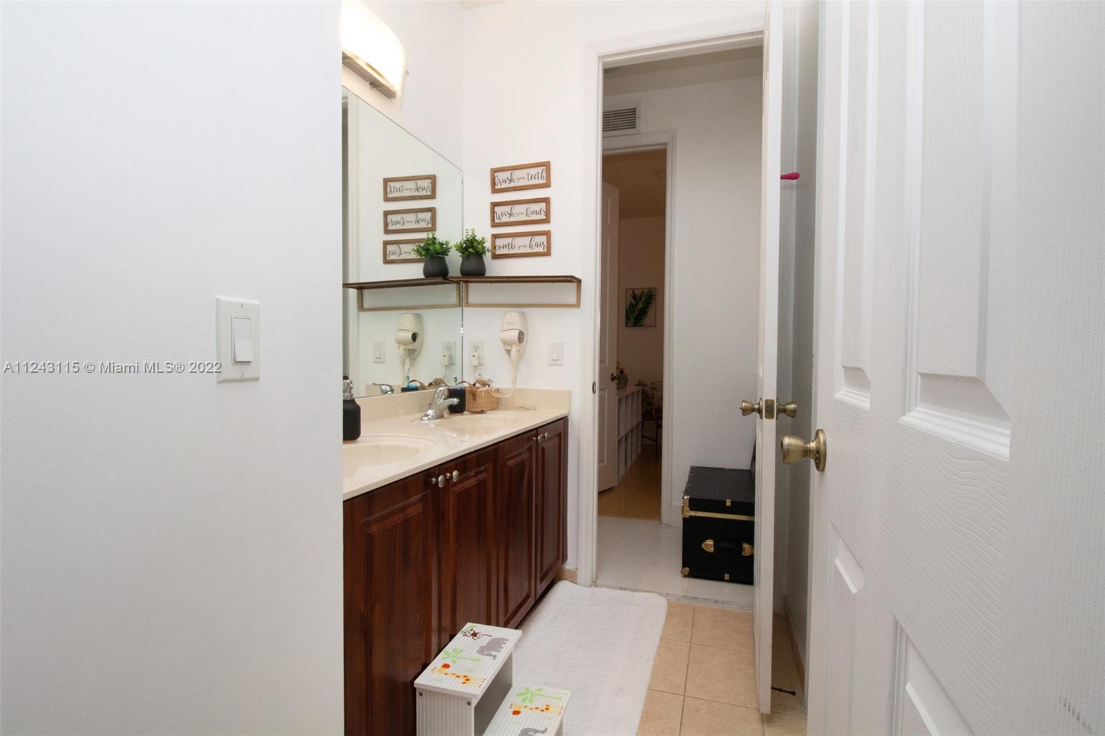 22737 Southwest 89th Path Cutler Bay, FL 33190 - Photo 8 of 27 a bathroom with a sink and a mirror