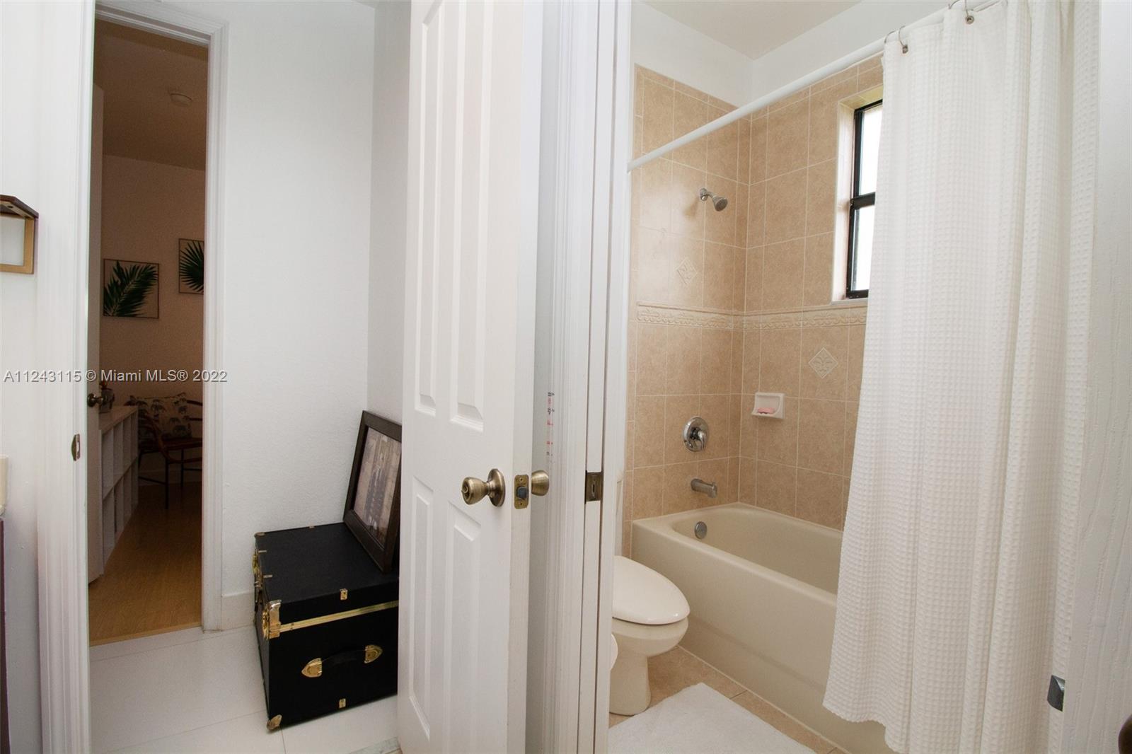 22737 Southwest 89th Path Cutler Bay, FL 33190 - Photo 9 of 27 a bathroom with a granite countertop bathtub shower and toilet