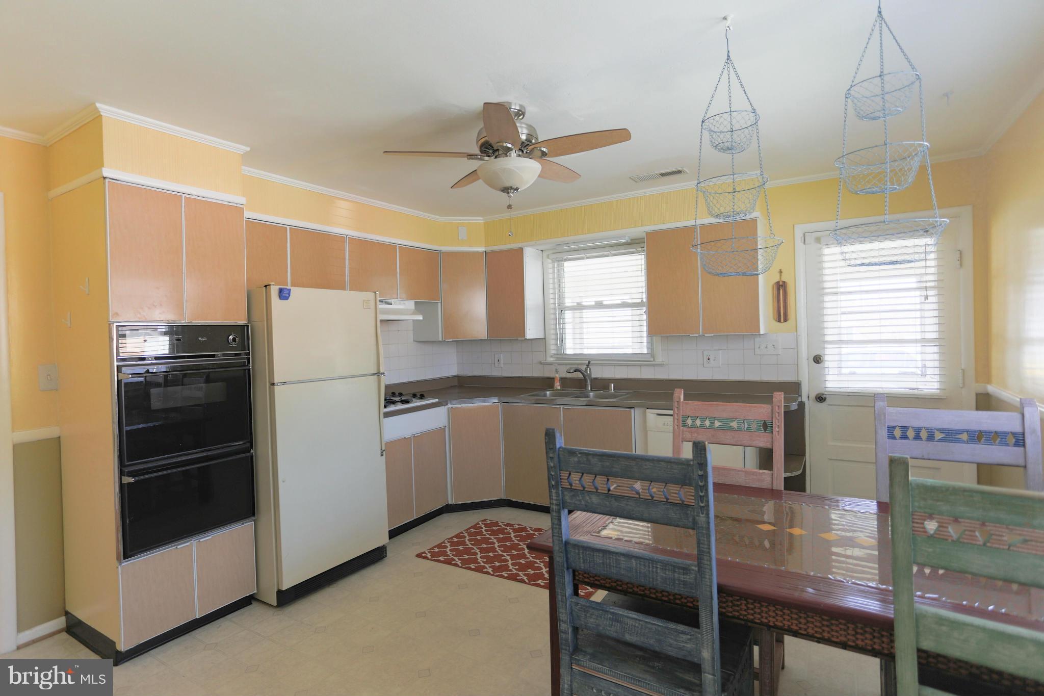 632 Londontown Road Edgewater, MD 21037 - Photo 4 of 28 a kitchen with refrigerator a stove a sink and a window
