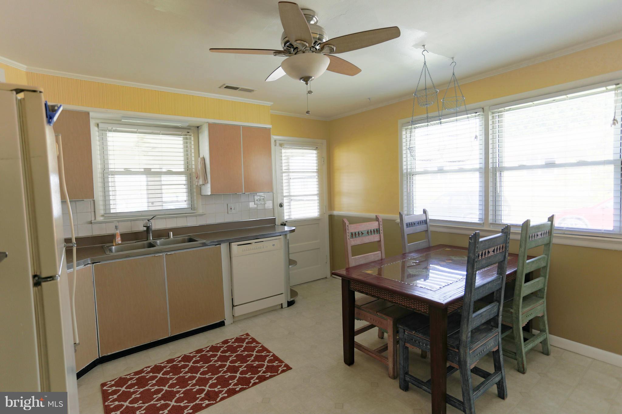 632 Londontown Road Edgewater, MD 21037 - Photo 6 of 28 a kitchen with a window dining table and chairs