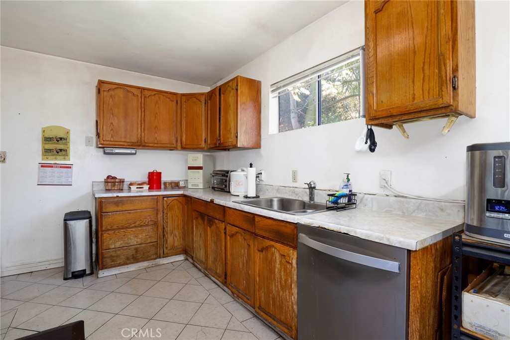 10358 Las Lunitas Avenue Tujunga, CA 91042 - Photo 14 of 38 a kitchen with a sink cabinets and window