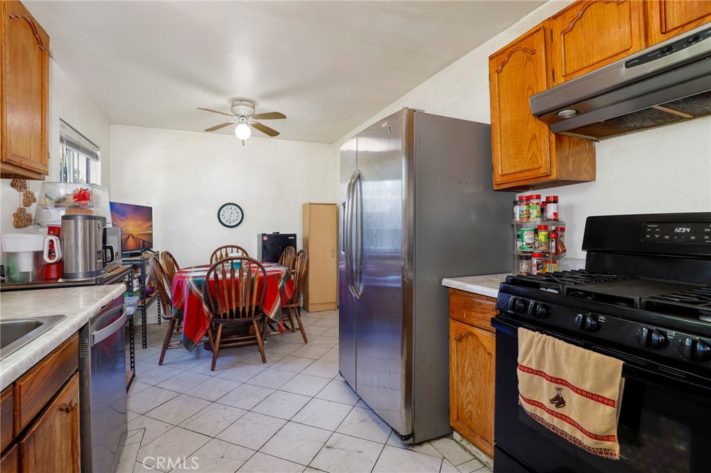10358 Las Lunitas Avenue Tujunga, CA 91042 - Photo 15 of 38 a kitchen with stainless steel appliances granite countertop a stove and a refrigerator
