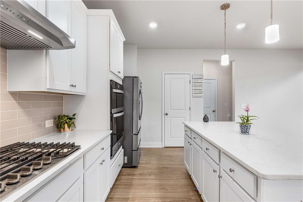 162 Carmichael Drive Canton, GA 30115 - Photo 11 of 57 a kitchen with stainless steel appliances a sink stove and refrigerator