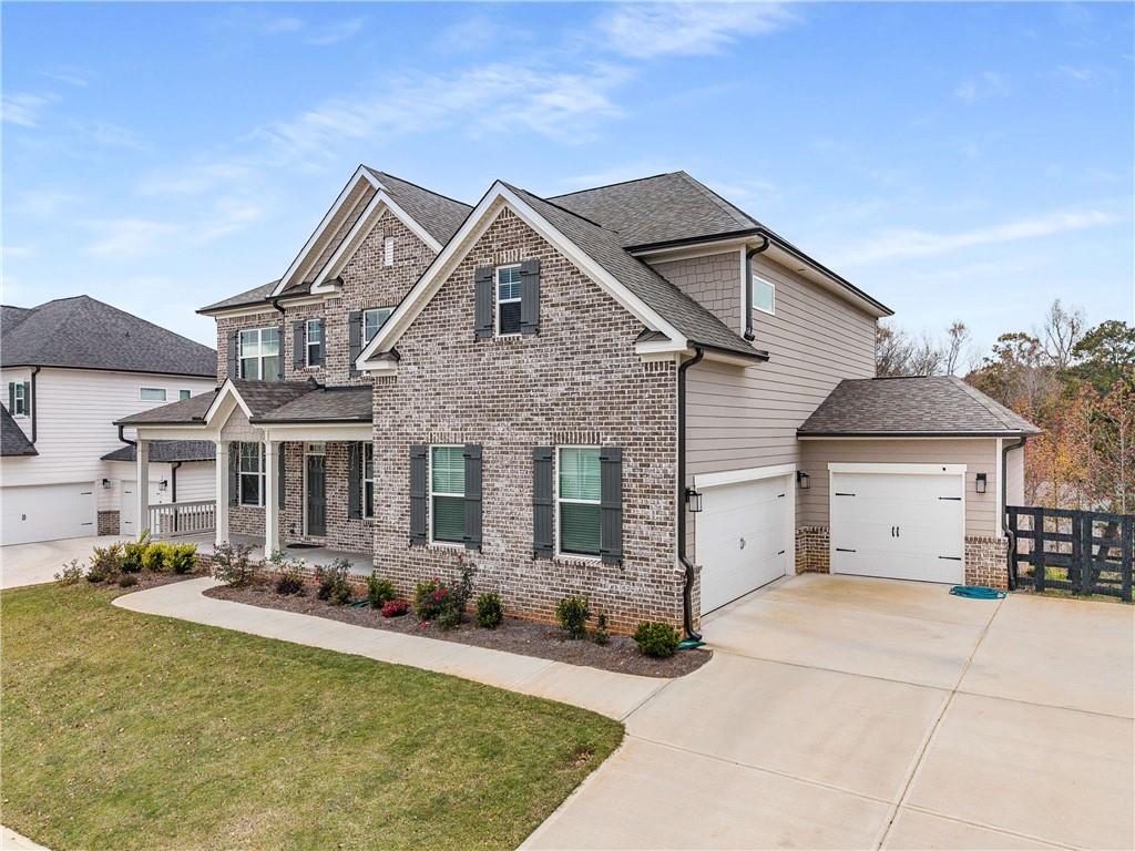 162 Carmichael Drive Canton, GA 30115 - Photo 2 of 57 a view of a white house with a small yard and large tree