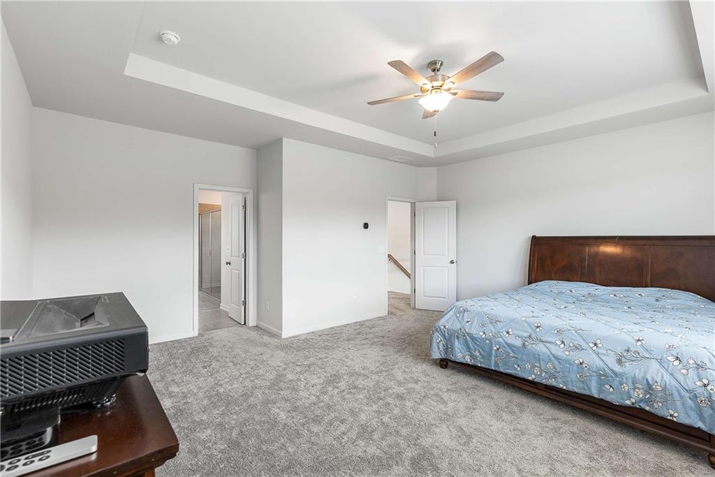 162 Carmichael Drive Canton, GA 30115 - Photo 31 of 57 a bedroom with a bed and a ceiling fan