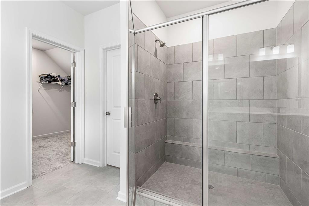 162 Carmichael Drive Canton, GA 30115 - Photo 34 of 57 a bathroom with a glass shower door