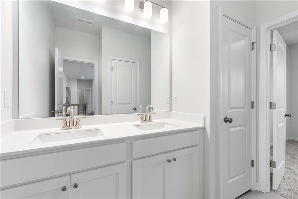 162 Carmichael Drive Canton, GA 30115 - Photo 42 of 57 a bathroom with double sink and a mirror
