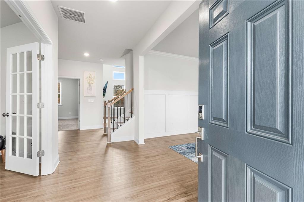 162 Carmichael Drive Canton, GA 30115 - Photo 5 of 57 a view of a hallway with wooden floor and staircase