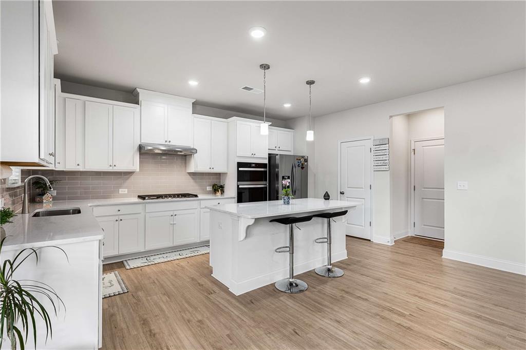 162 Carmichael Drive Canton, GA 30115 - Photo 6 of 57 a kitchen with stainless steel appliances kitchen island granite countertop a sink and cabinets