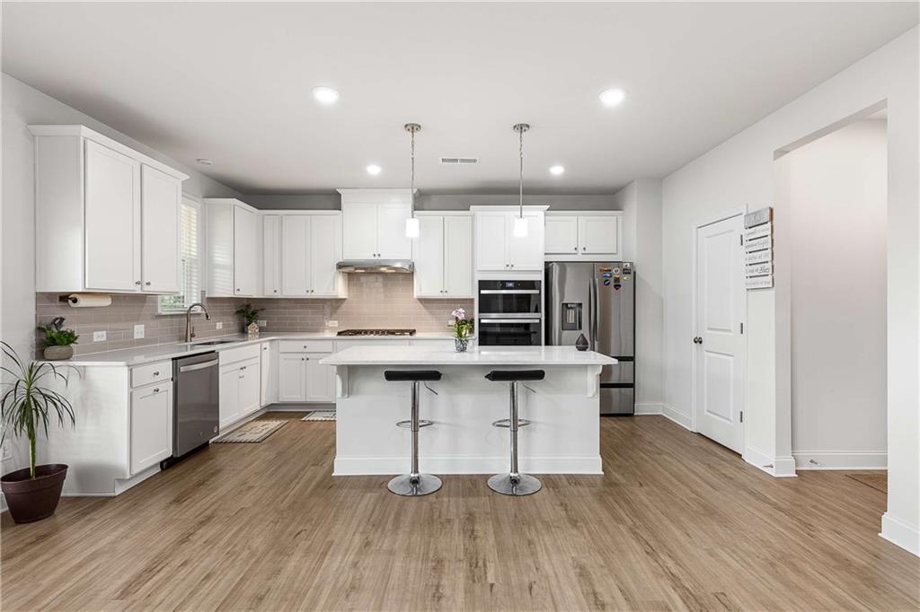 162 Carmichael Drive Canton, GA 30115 - Photo 7 of 57 a kitchen with stainless steel appliances a stove a sink a refrigerator and cabinets