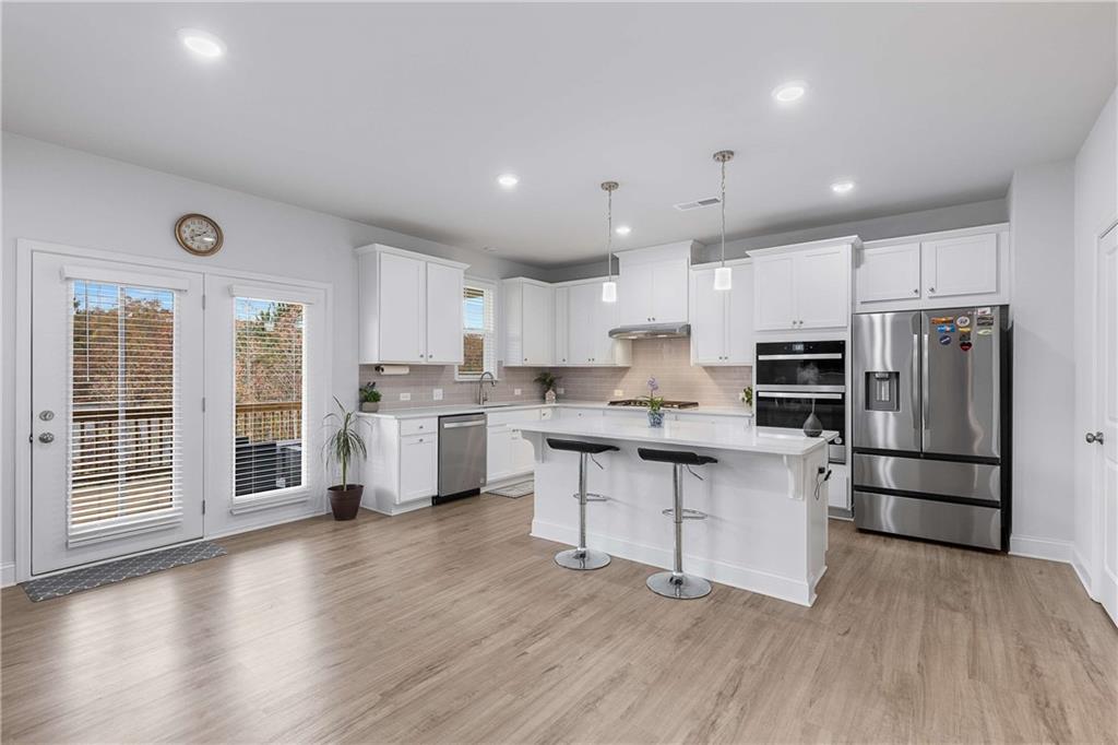 162 Carmichael Drive Canton, GA 30115 - Photo 8 of 57 a kitchen with stainless steel appliances a refrigerator sink and cabinets