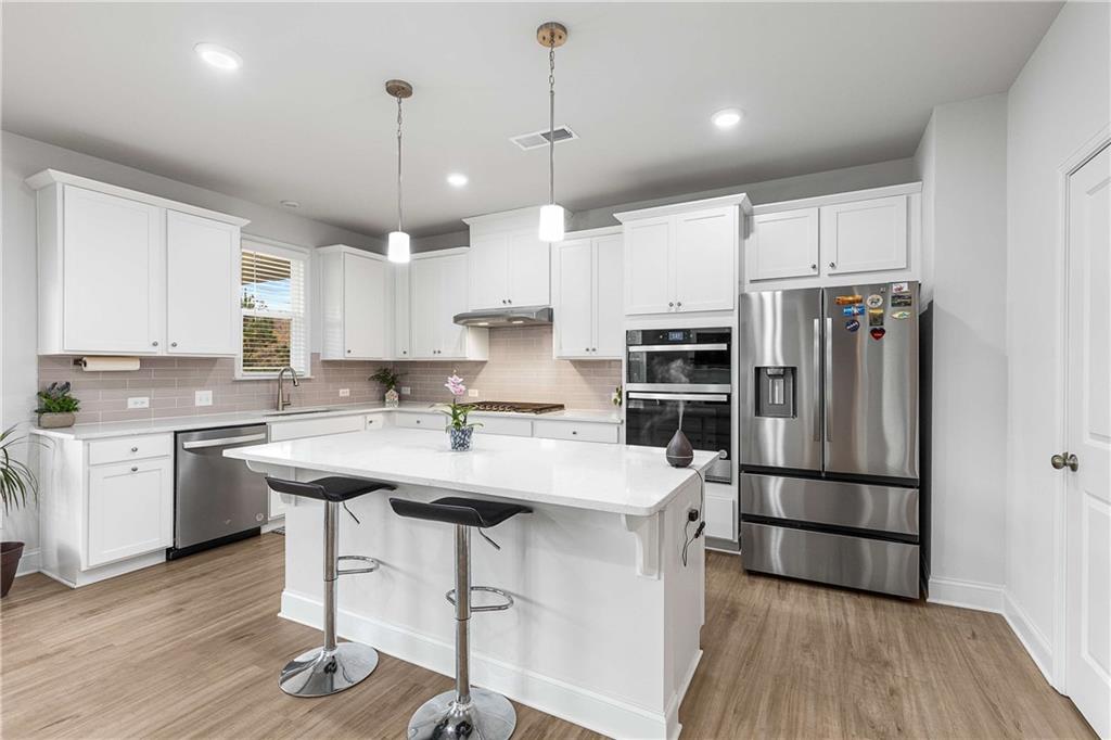 162 Carmichael Drive Canton, GA 30115 - Photo 9 of 57 a kitchen with stainless steel appliances granite countertop a sink stove and refrigerator