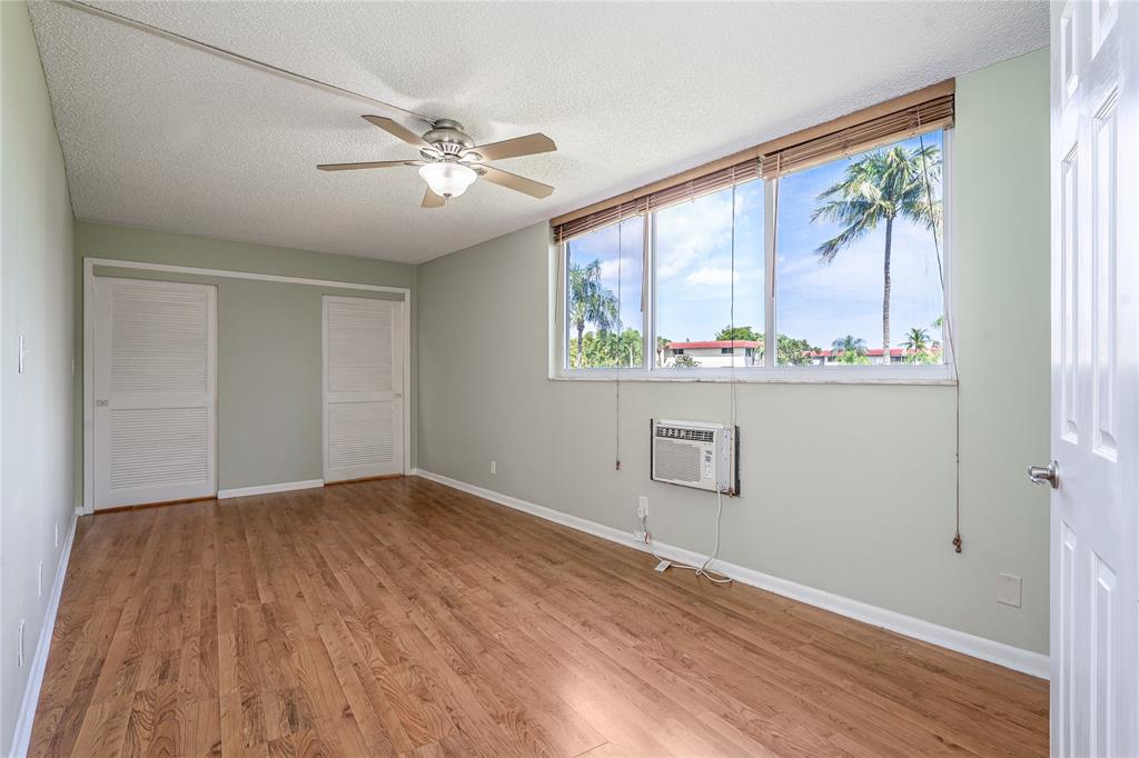 9720 South Hollybrook Lake Drive, Unit 205 Pembroke Pines, FL 33025 - Photo 11 of 57 a view of an empty room with a window and wooden floor