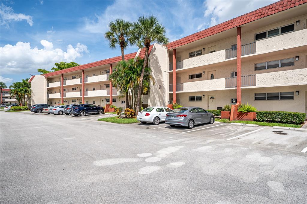 9720 South Hollybrook Lake Drive, Unit 205 Pembroke Pines, FL 33025 - Photo 21 of 57 a view of a cars parked in front of a building