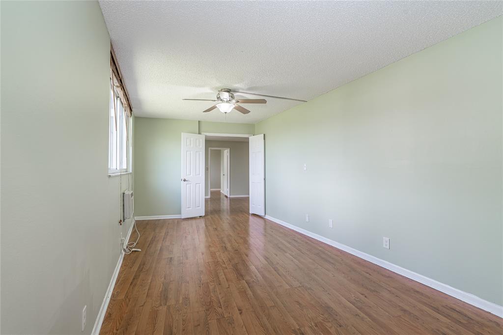 9720 South Hollybrook Lake Drive, Unit 205 Pembroke Pines, FL 33025 - Photo 9 of 57 an empty room with wooden floor and chandelier fan