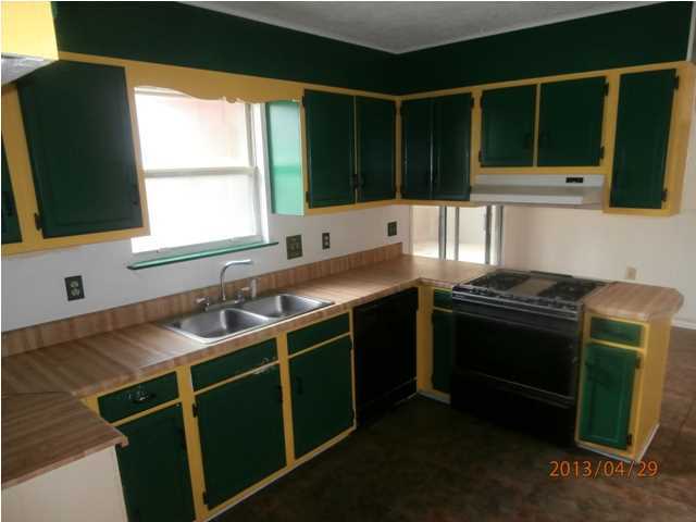 381 Roberts Road East DeFuniak Springs, FL 32433 - Photo 3 of 16 a kitchen with a sink stove and microwave