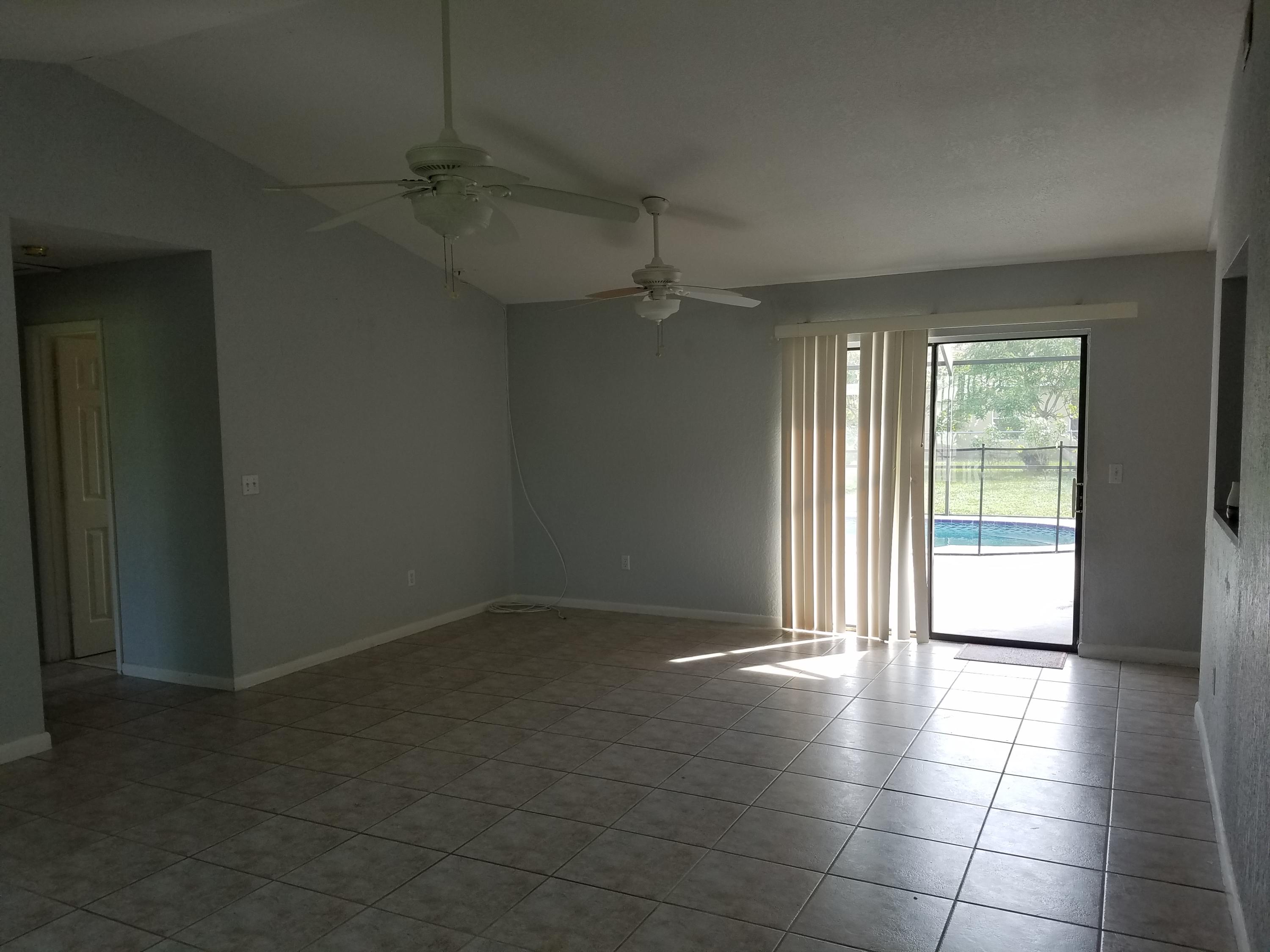 934 Southwest Longfellow Road Port St. Lucie, FL 34953 - Photo 2 of 26 living room towards sliding door