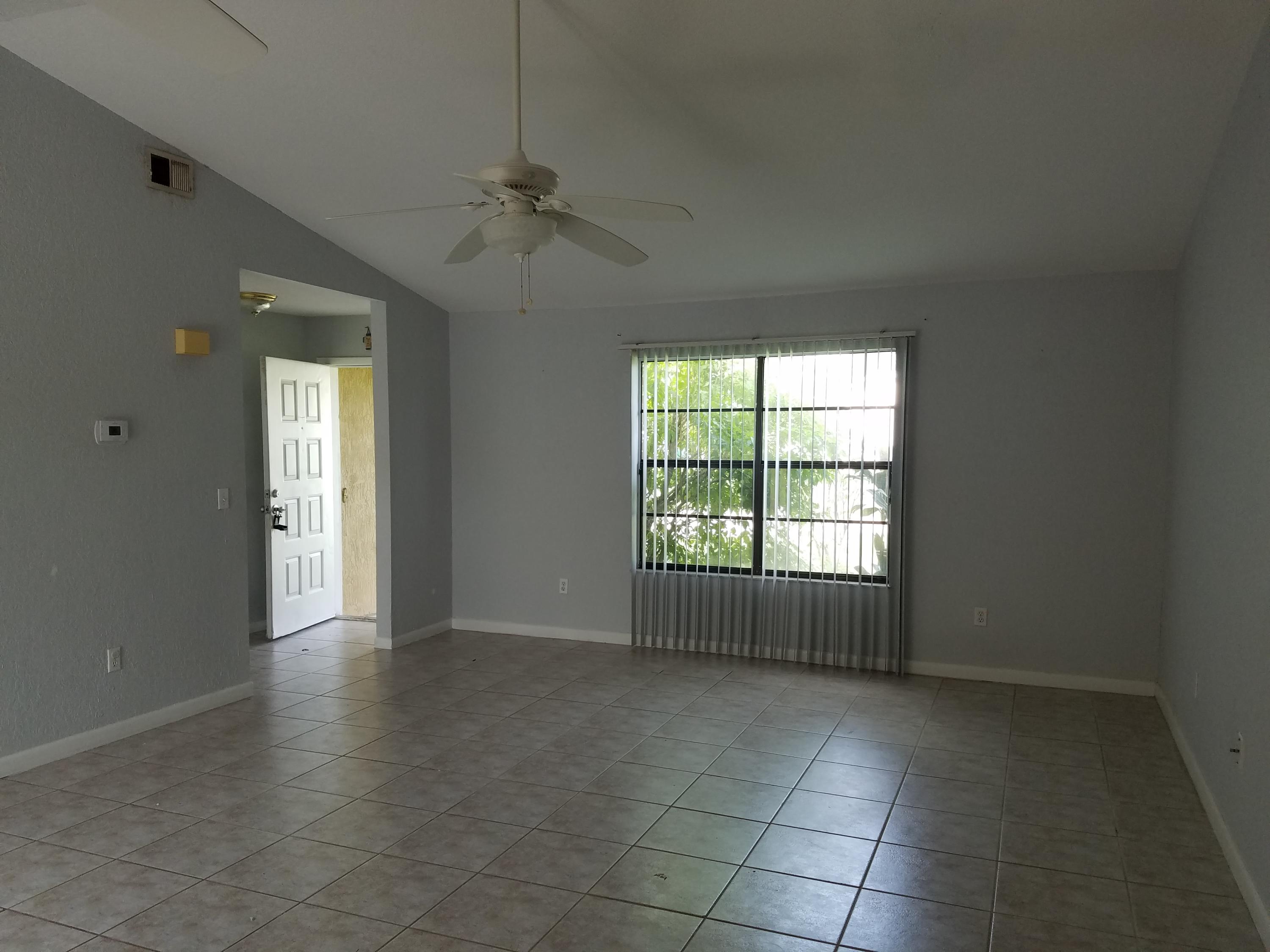 934 Southwest Longfellow Road Port St. Lucie, FL 34953 - Photo 3 of 26 living room towards front door